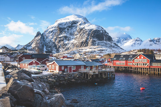 Beautiful super wide-angle winter snowy view of fishing village A, Norway, Lofoten Islands, with skyline, mountains, famous fishing village with red fishing cabins, Moskenesoya, Nordland