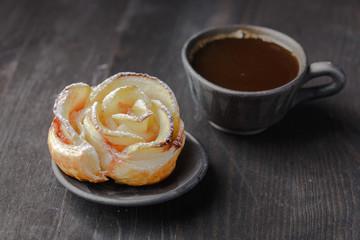 cup of coffee and a bun in the form of a rose,homemade buns with jam,homemade baking,puff pastries with a cup of coffee