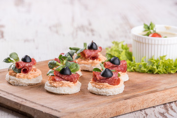 Canapes with salami and spices