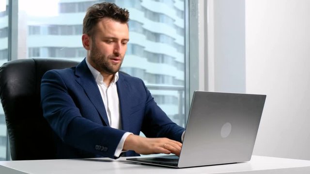 Businessman typing on the laptop in office