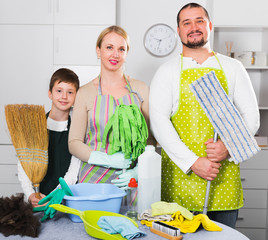 Happy family with cleaning accessories