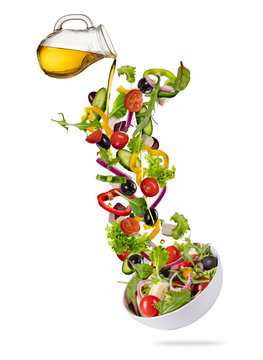 Flying vegetable greek salad isolated on white background.