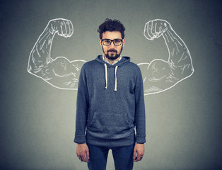 confident strong man hipster on wall background