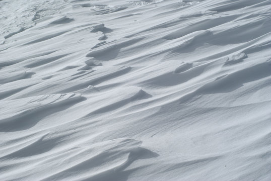 background - surface of firn field with hummocks on the mountain slope