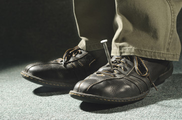 nail holding shoe and foot in place