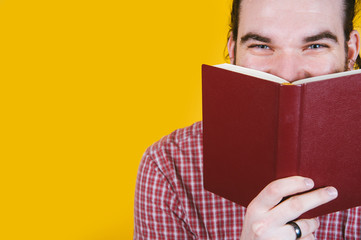Man dreamily reading a book - close-up of the eyes