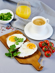 Fototapeta na wymiar Morning Coffee White Cup Beverage Orange Juice Sandwich with Tasty Fried Egg Served on a Wooden Tray Parsley Pepper Tomato Cherry Grey Background Healthy Food Concept Vegetarian Modern Lifestyle 