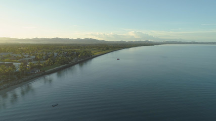 AERIAL: Tropical sunrise illuminates high end hotel complex and golf course.