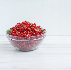 red currant in a plate, on background