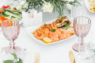 Fish platter. Plate with seafood on the table, snacks at the banquet, wedding banquet, table setting, dinner food, gala dinner.