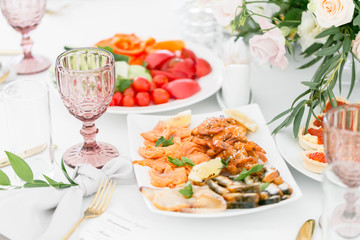 Fish platter. Plate with seafood on the table, snacks at the banquet, wedding banquet, table setting, dinner food, gala dinner.