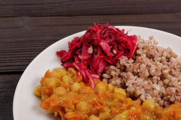 Stewed carrots with chickpeas and buckwheat on a table