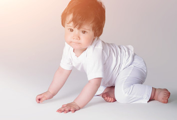 Happy crawling baby. Side view