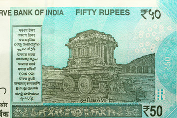 A new banknote of India with a denomination of 50 rupees. Indian currency. The other side, Hampi's...