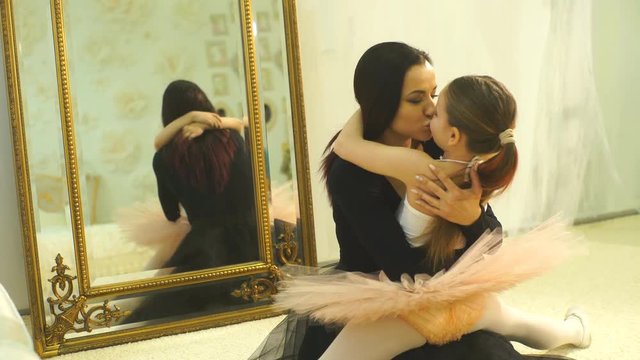 mom ballerina hugs her daughter ballerina