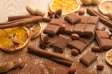 Milk chocolate with nuts and spices. Macro.