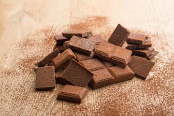 Milk chocolate on a wooden texture