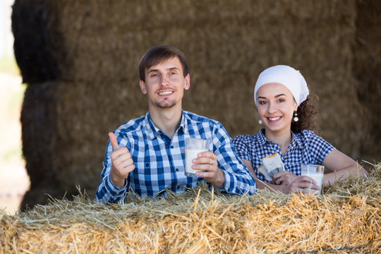 man and woman in hay with milk