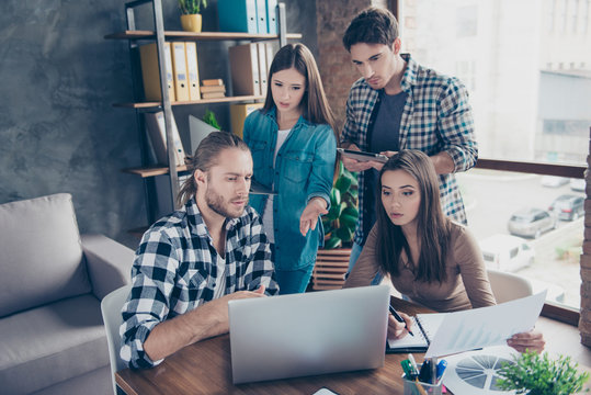 Thoughtful, concentrated, confident, professional business team in casual outfit having meeting, discussing new project, start-up, using modern technologies in workstation