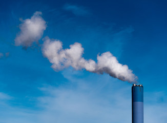 The Cloudmaker -  big blue chimney gives white Steam in the blue Sky