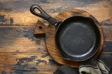 Empty cast iron  pan .Culinary background,top view with copy space.
