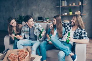 When will the wedding happen? Portrait of cheerful joyful cute talkative handsome attractive friends telling the latest news sitting on a sofa spending time together