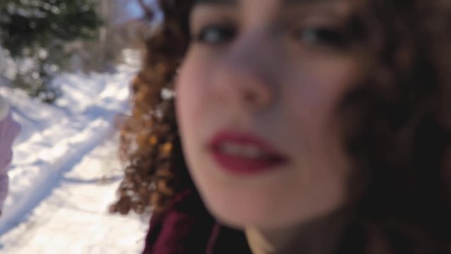 Cute curly hair girl make kiss outdoor at snowy day