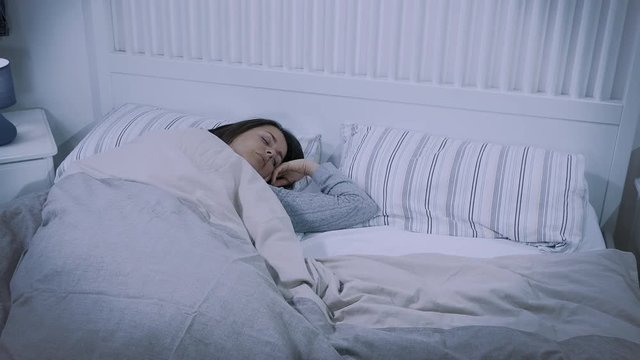 Husband entering in bed at night cuddling sleepy wife cute