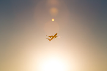 passenger airplane starting in the evening sun