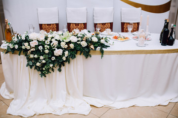 wedding table of the newlyweds decorated with a flower arrangement