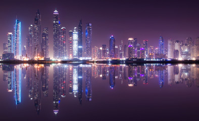 Panoramic view of Dubai Marina skyline with reflection at night, UAE