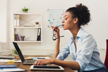 Serious business woman working on laptop at office