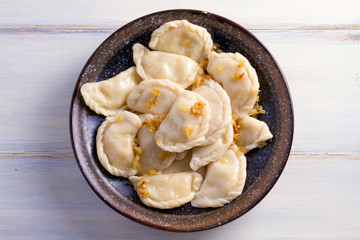 Plate of pierogi or varenyky, vareniki, Dumplings, filled with potato. Pyrohy - dumplings with filling. View from above, top, overhead
