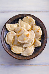 Plate of pierogi or varenyky, vareniki, Dumplings, filled with potato. Pyrohy - dumplings with filling. View from above, top, overhead