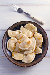 Plate of pierogi or varenyky, vareniki, Dumplings, filled with potato. Pyrohy - dumplings with filling. View from above, top, overhead