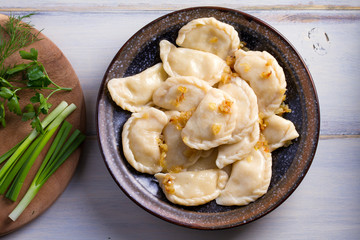 Plate of pierogi or varenyky, vareniki, Dumplings, filled with potato. Pyrohy - dumplings with filling. View from above, top, overhead