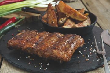 fried pork ribs with potatoes and spices