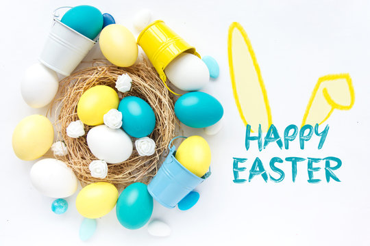 colored blue and yellow Easter eggs in nest on wooden background, selective focus image. Happy Easter card 