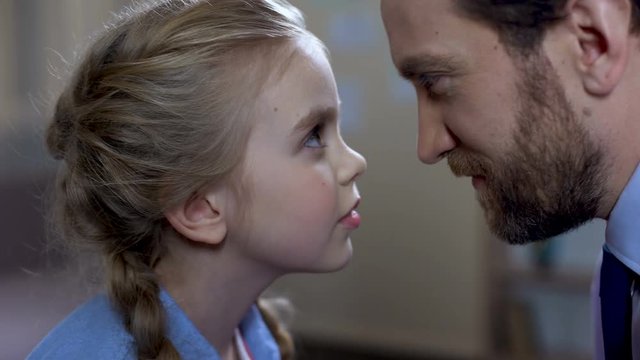 Loving father and daughter touching noses, family connection, tender attitude