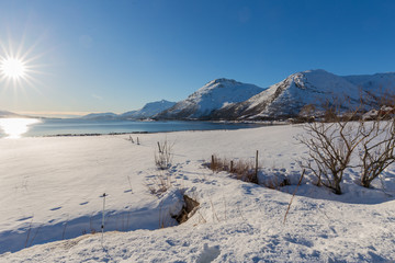 Scenic winter view over fjord and snowy mountains from Kongsvika