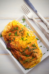 Wrapped omelette with grated cheese. Egg dish. Fried eggs. Breakfast food. overhead