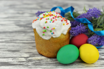 baking cake with icing glaze bread with eggs in a basket colored on a wooden background