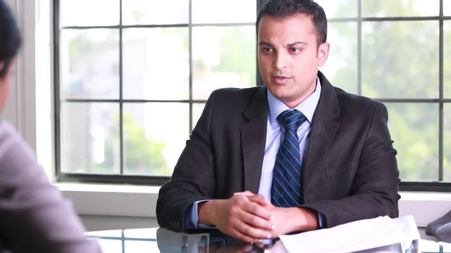 Closeup portrait, guy in suit blazer and tie delivering breaking bad news to worker, isolated windows office background. Negative emotions facial expressions feelings