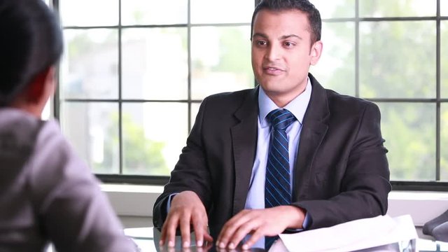 Closeup portrait, guy in suit blazer and tie giving delivering good news to employee, isolated windows background. Positive emotions facial expressions body language