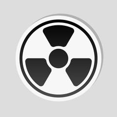 hazard, radiation. simple silhouette. Sticker style with white border and simple shadow on gray background