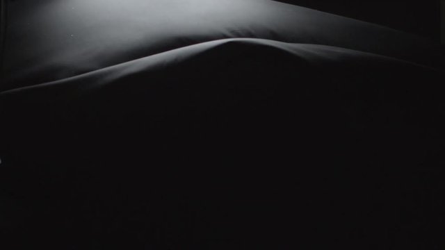 Black Clothing floating down in super slow motion 240fps. Abstract visual of black clothing floating down the frame