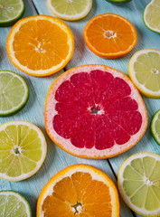 Fototapeta na wymiar citrus fruit slices on turquoise background