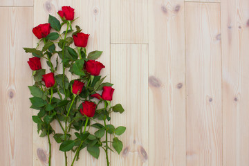 Red roses on the wooden background