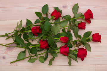 Red roses on the wooden background