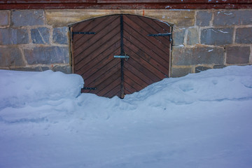 Close up of traditional Norwegian mountain wooden houses, door with snow in stunning nature in Norway